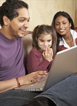 Indian family looking at laptop