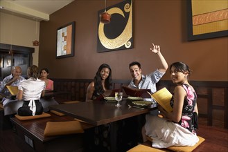Multi-ethnic friends at restaurant