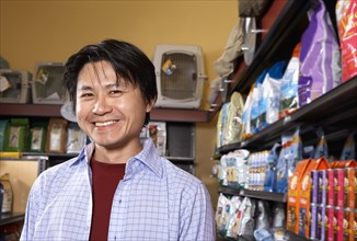 Asian man in pet store