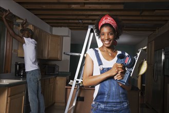African American couple remodeling house