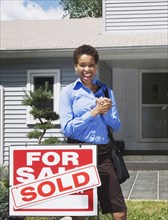 African American woman in front of new house