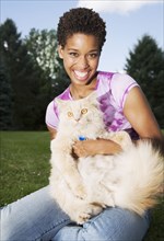 African American woman holding cat