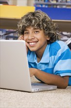 Hispanic boy typing on laptop