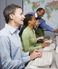 Multi-ethnic businesspeople typing on computers