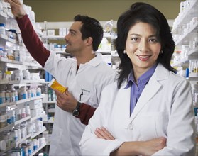 Asian pharmacist in front of coworker