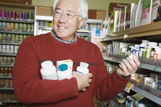 Senior Asian man shopping for natural medicine