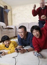 Multi-generational Asian family playing video games