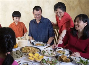 Asian family eating at dinner table