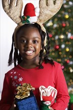 African girl holding Christmas gifts