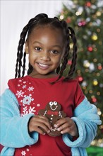 African girl holding Christmas cookie
