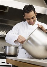 Hispanic male chef mixing batter
