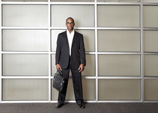 Mixed race businessman standing in modern office