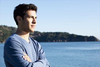 Mixed race man overlooking waterfront
