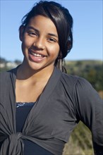 Hispanic teenage girl smiling outdoors