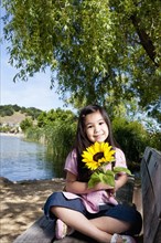 Girl holding sunflower