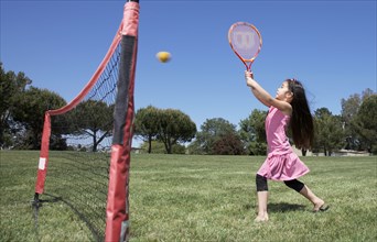 Girl  playing tennis in park
