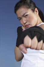 Chinese woman kick boxing outdoors