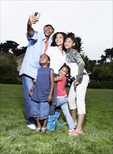 Family taking picture together in park