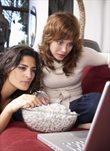 Women watching movie on laptop together
