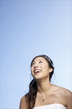 Chinese bride standing under blue sky