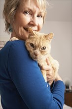 Senior Caucasian woman holding cat