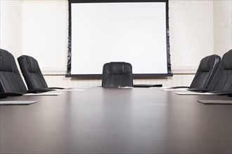 Empty chairs at conference table