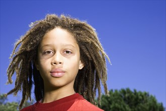 Mixed race boy standing outdoors