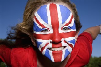 Caucasian girl with United Kingdom flag painted on face