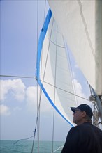 Senior Caucasian man standing on sailboat