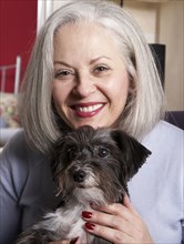 Senior Caucasian woman petting dog