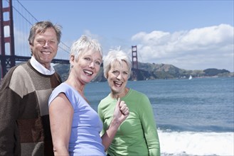 Senior Caucasian friends smiling by Golden Gate Bridge