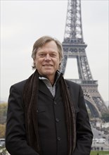 Caucasian man standing in front of Eiffel Tower