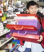 Chinese boy buying school supplies in store