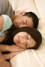 Chinese couple sleeping in bed