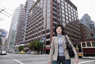 Chinese businesswoman standing on city street
