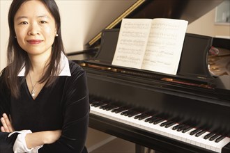 Chinese woman sitting at piano