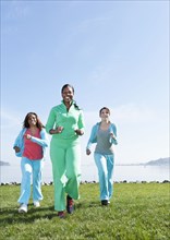 Women jogging by rural lake