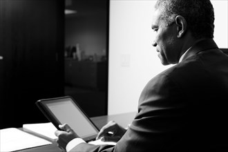 African American businessman using electronic tablet