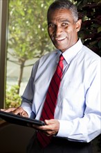 African American businessman using electronic tablet