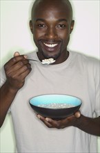 Portrait of African man eating cereal