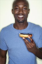 Portrait of African man eating bagel
