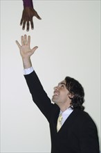 Businessman reaching up for hand