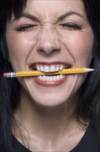 Close up of woman biting pencil