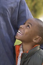 African boy smiling up at parent