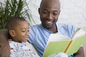 African father and son reading