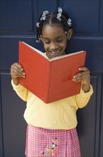 African girl reading book