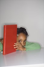 African girl holding book