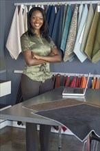 African businesswoman next to fabric swatches