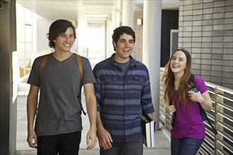College students laughing in corridor
