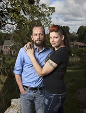 Caucasian couple hugging outdoors